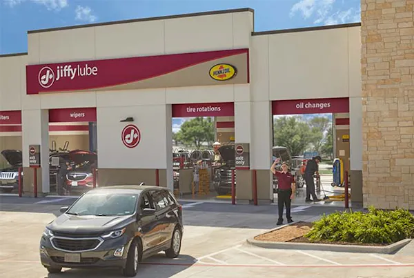 Jiffy Lube employee waving goodbye at customer
