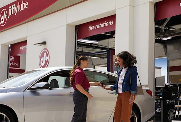 Jiffy Lube employee handing keys to customer