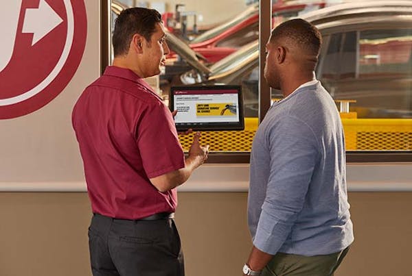 Jiffy Lube employee walking customer through service review