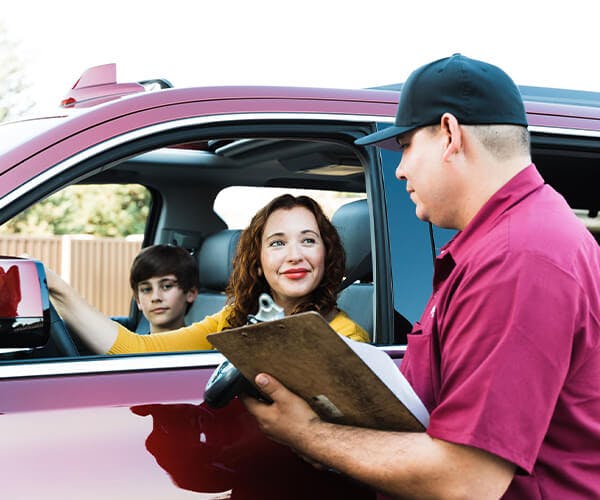 Jiffy Lube employee reviewing information with customer