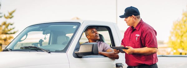 Jiffy Lube employee reviewing information with customer