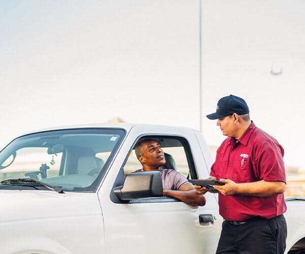 Jiffy Lube employee reviewing information with customer