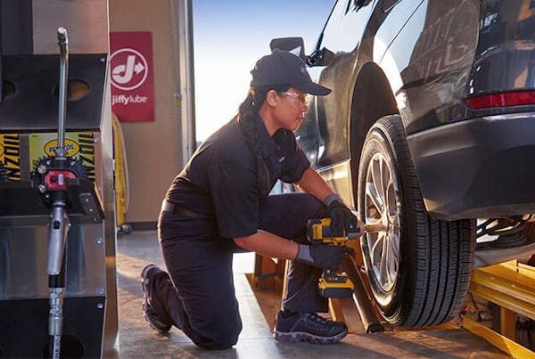 Jiffy Lube employee changing tires