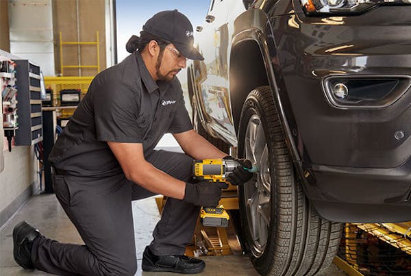 Jiffy Lube employee changing tires