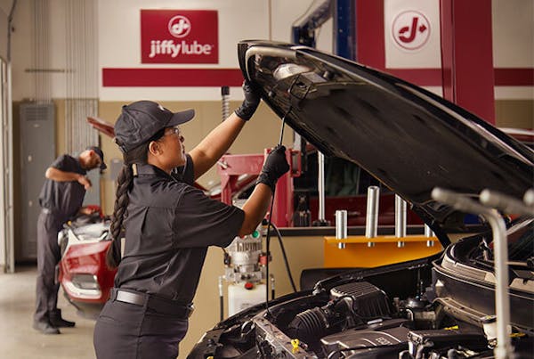 Jiffy Lube employee looking under the hood