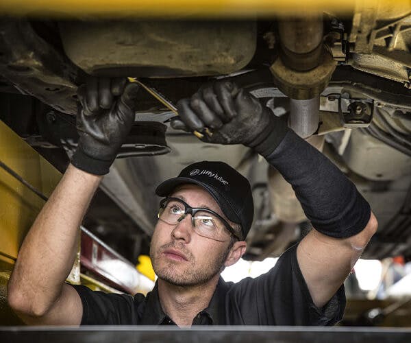 Jiffy Lube employee working underneath a vehicle