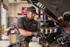 jiffy lube employee replacing a car battery