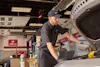 a jiffy lube trained technician performing an oil change