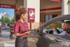 A Jiffy Lube Tech greeting a customer 