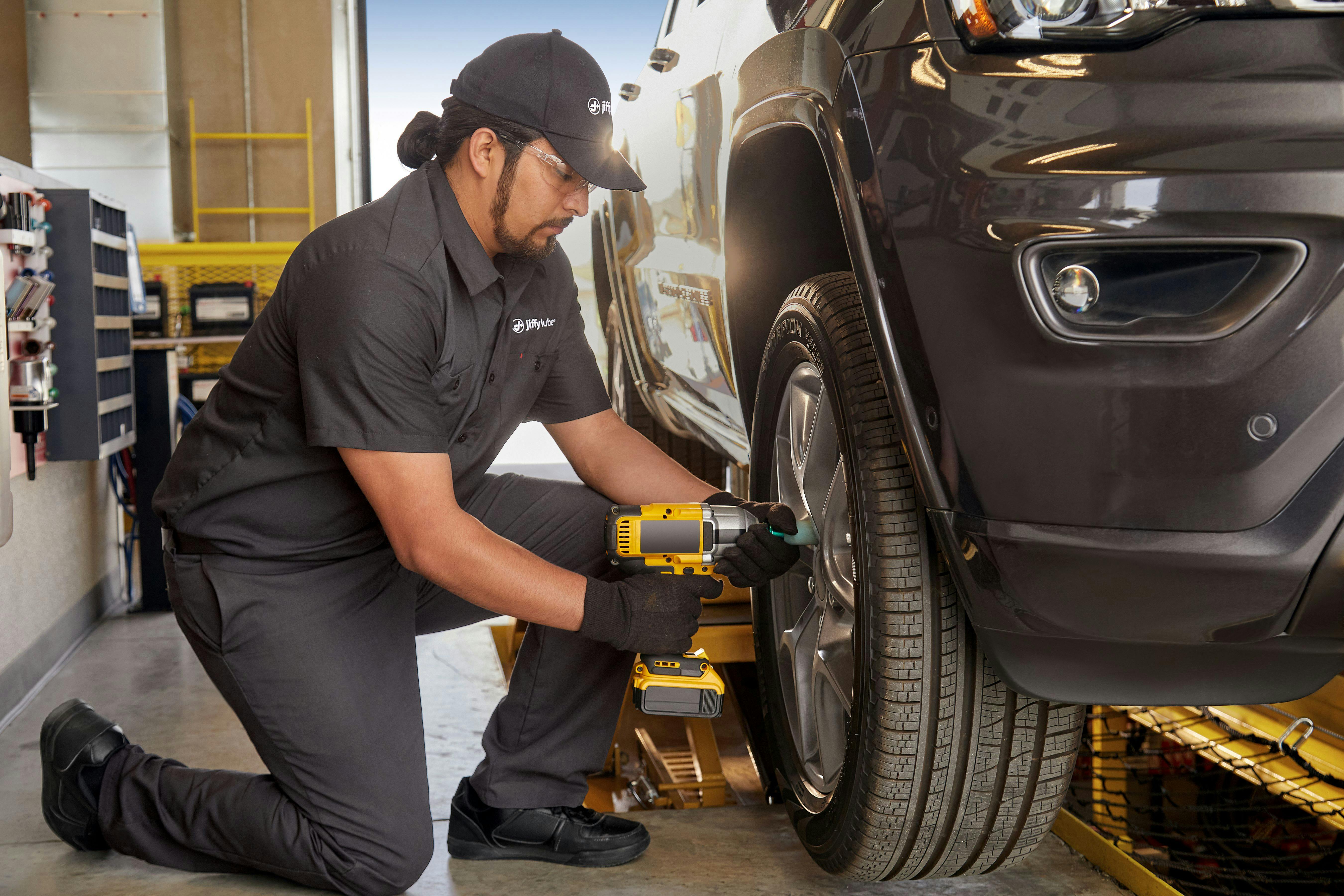 Jiffy Lube Technician Working on a Tire Rotation