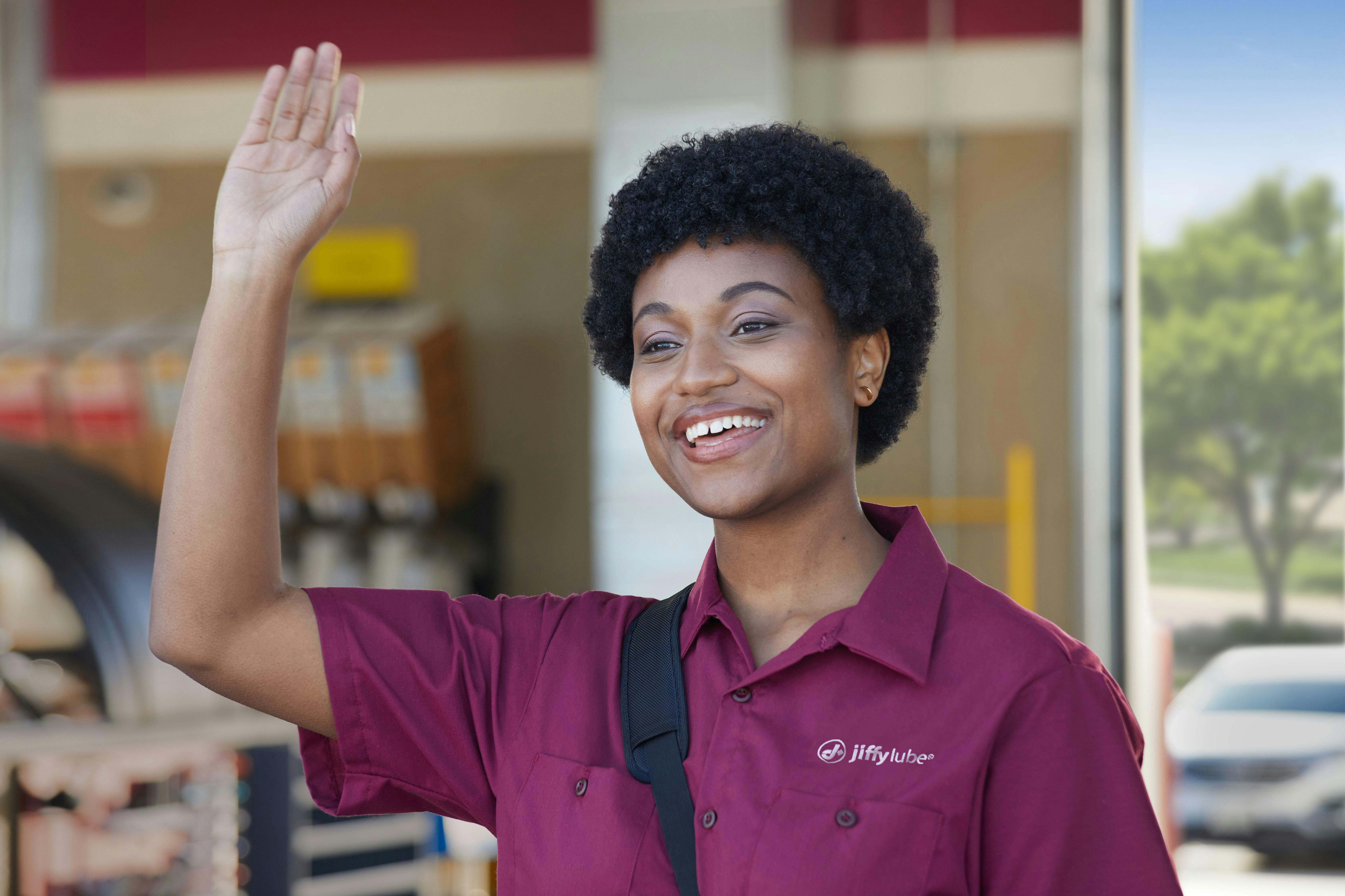 Jiffy Lube employee waving goodbye to a customer