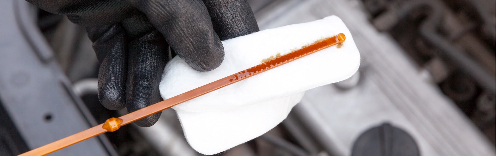 Checking a vehicle's engine oil level using a dipstick