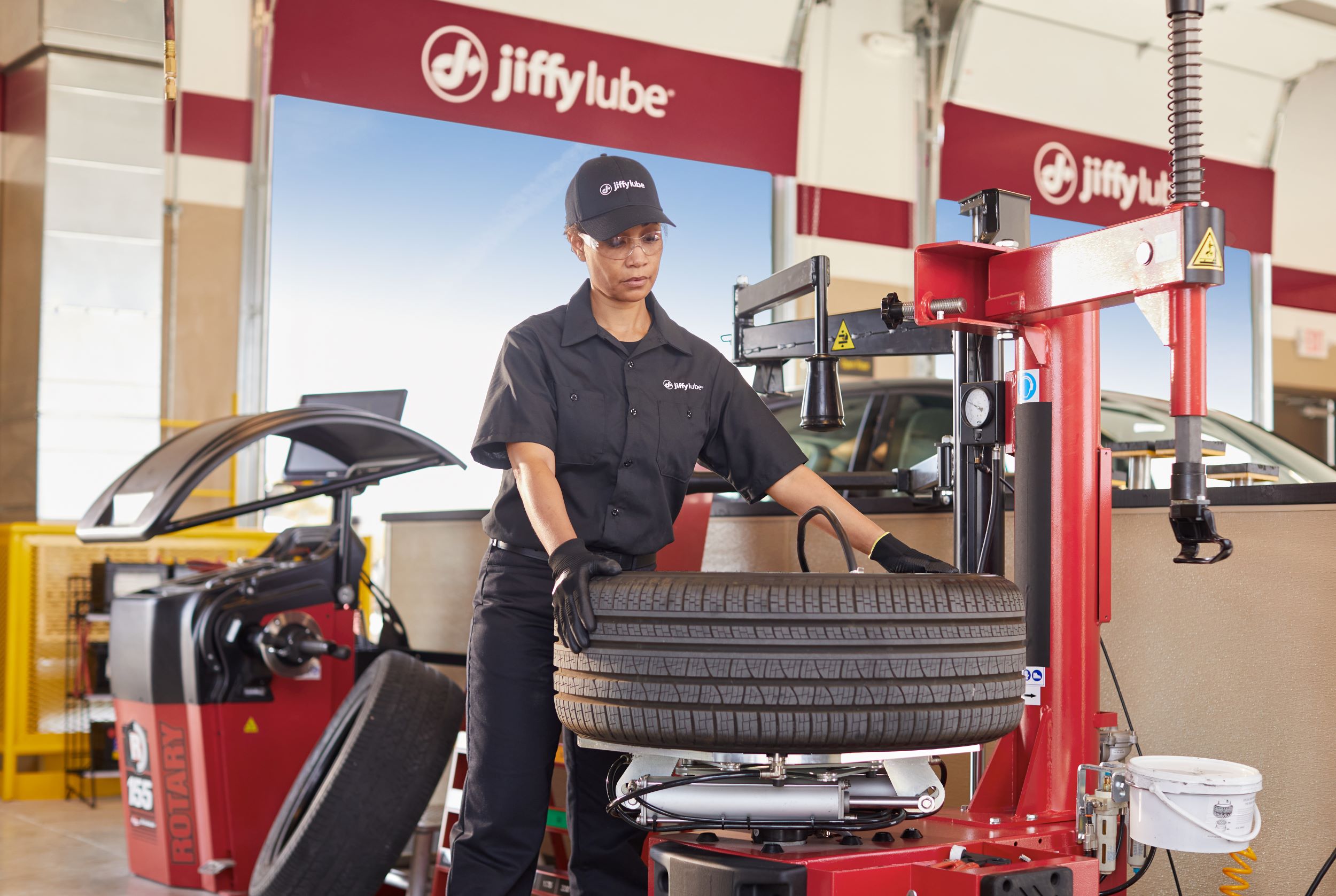 jiffy lube employee performing a tire inspection