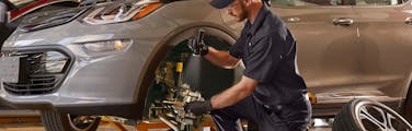 jiffy lube employee inspecting brake pads