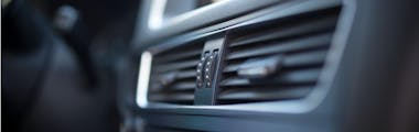 A close up of a vehicle's cabin air vents, which may be failing to pump cool air due to an AC leak, clogged cabin filter or other AC system malfunction