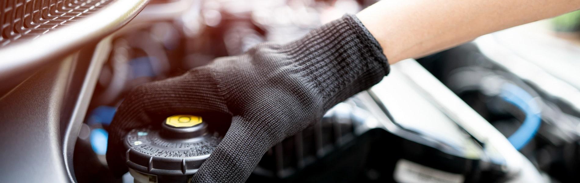 A Jiffy Lube technician performing a brake fluid exchange