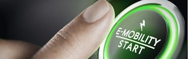 finger pressing the start button of electric vehicle
