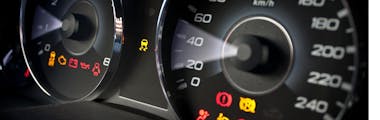 Speedometer displaying dashboard warning lights